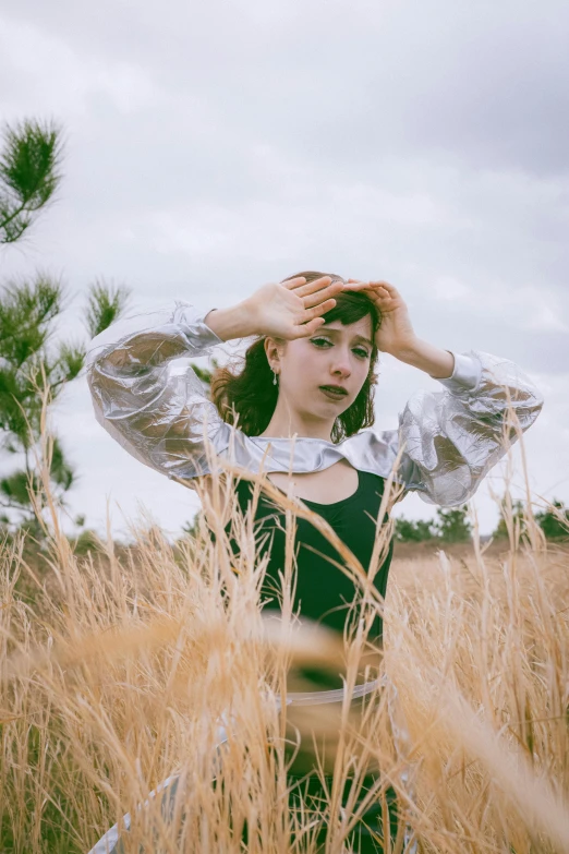 a woman that is wearing a head band and standing in a field