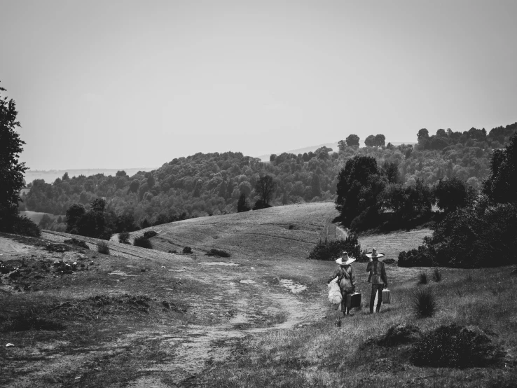 an older couple is walking across a field