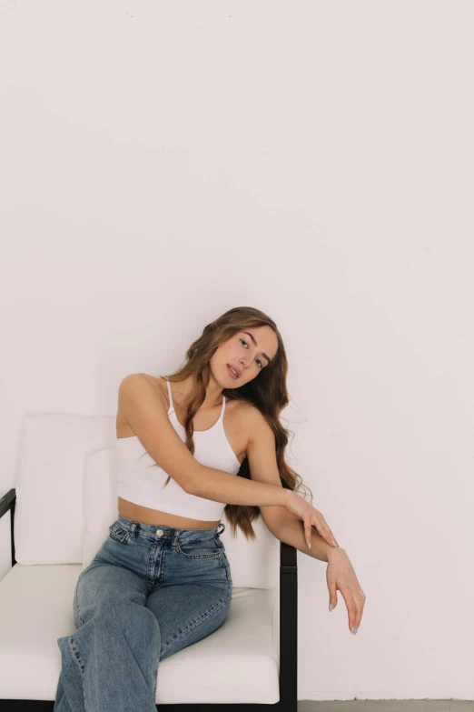 a woman sitting on top of a white chair