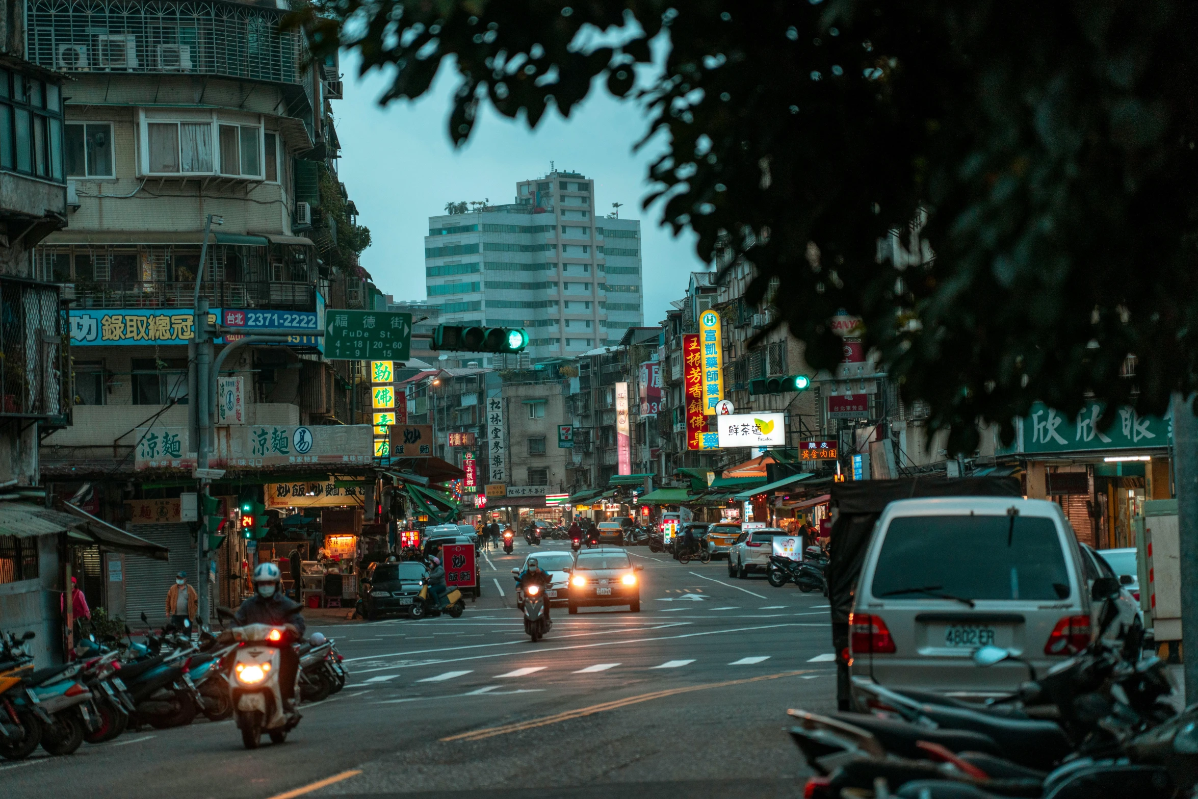 a view of a city street with lots of traffic