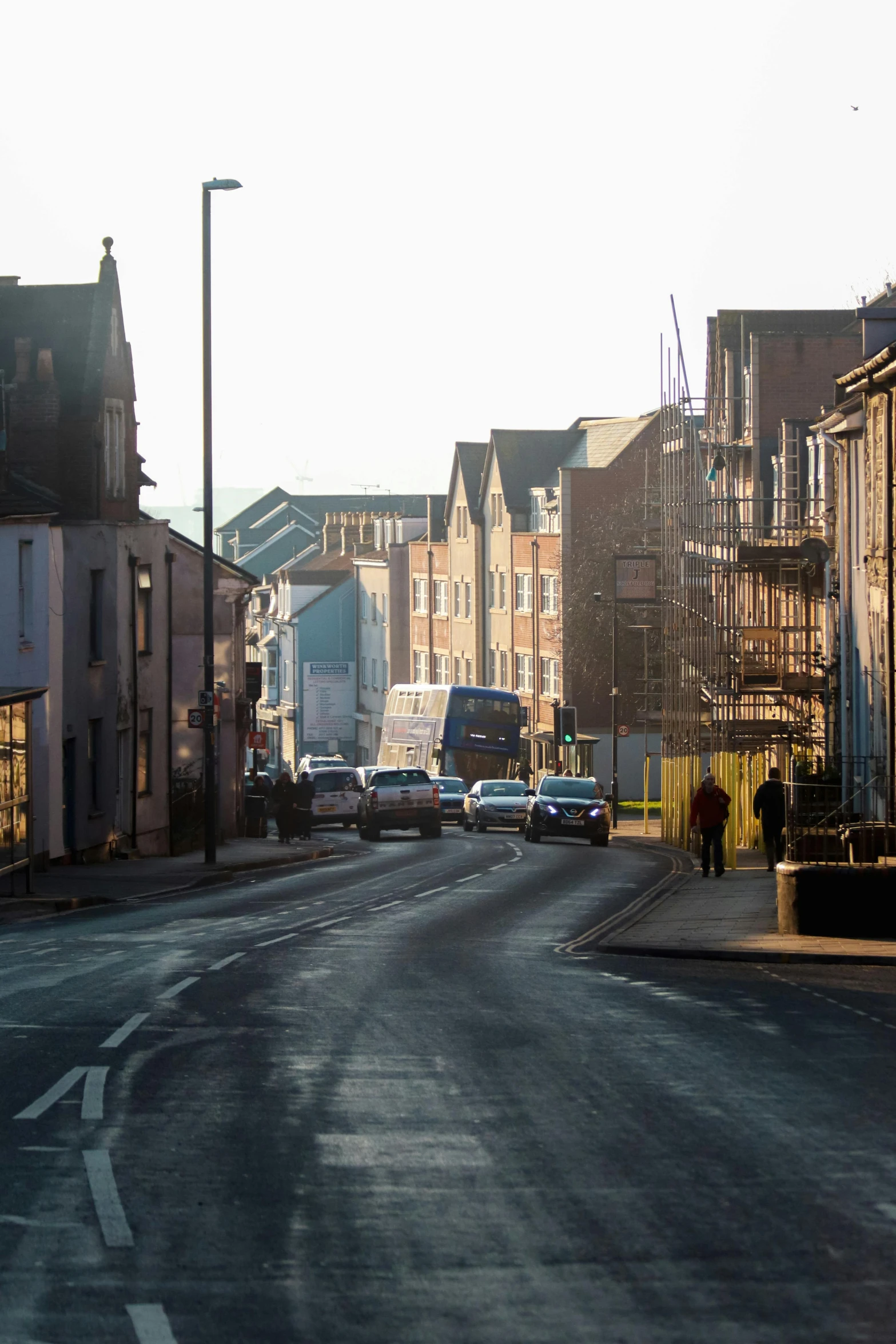 a street with some cars parked along the side of it