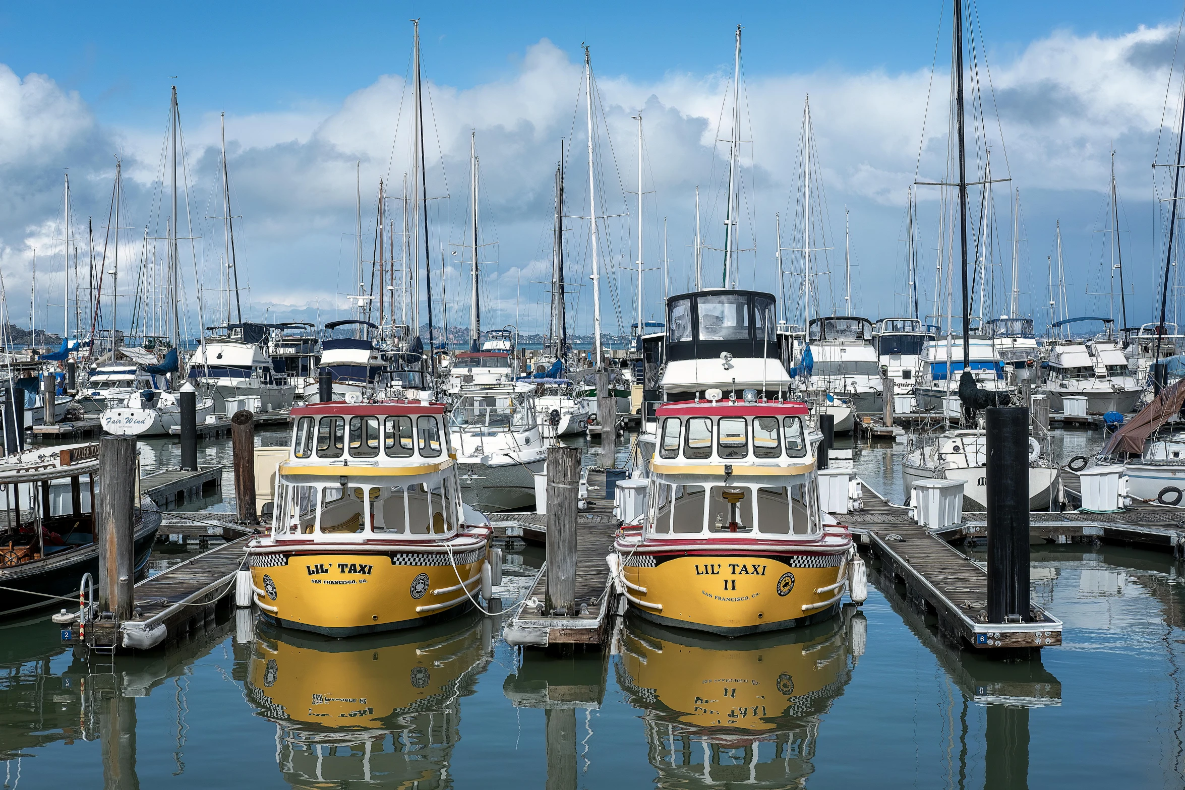 some yellow boats are docked at the dock