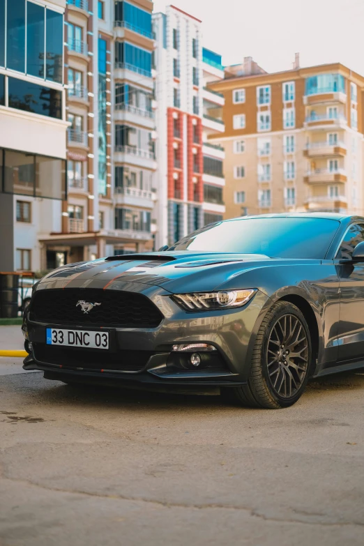 grey ford mustang in city parking lot during daytime