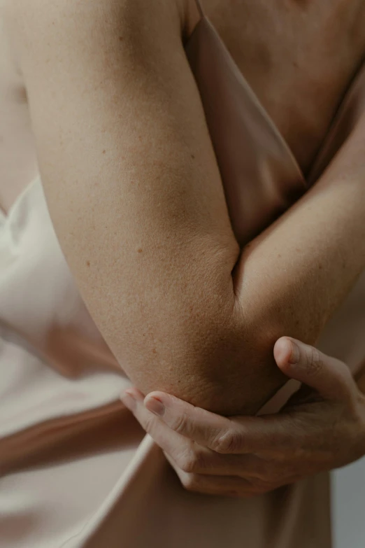 the arm of a person standing wearing a dress