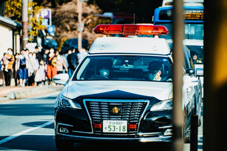 an suv with red light on top drives down the street