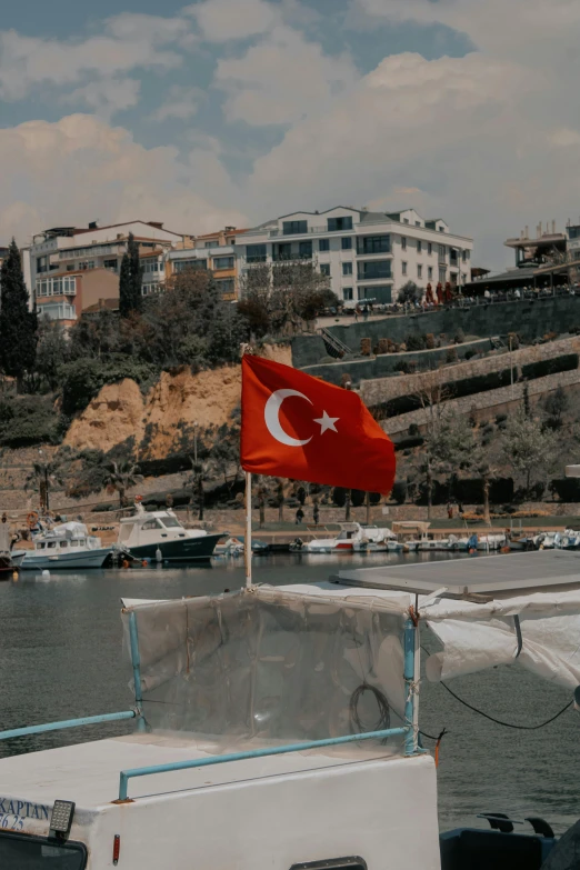 a flag that is sticking out of the back of a boat