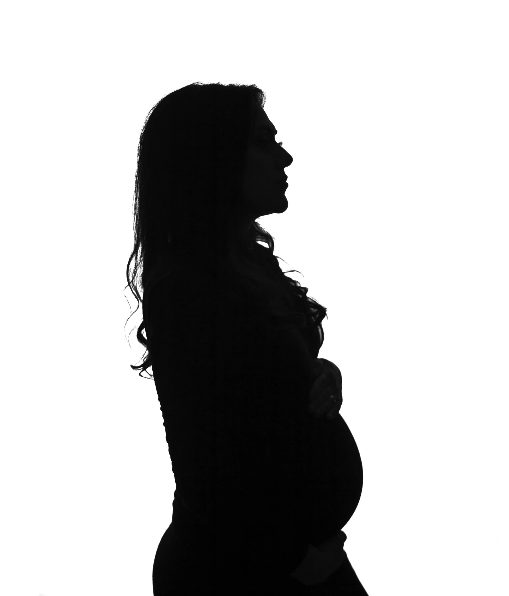 a silhouette of a pregnant woman in a black dress