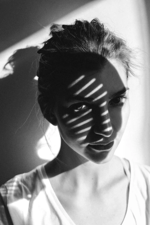 black and white po of woman with shadow cast by a sun