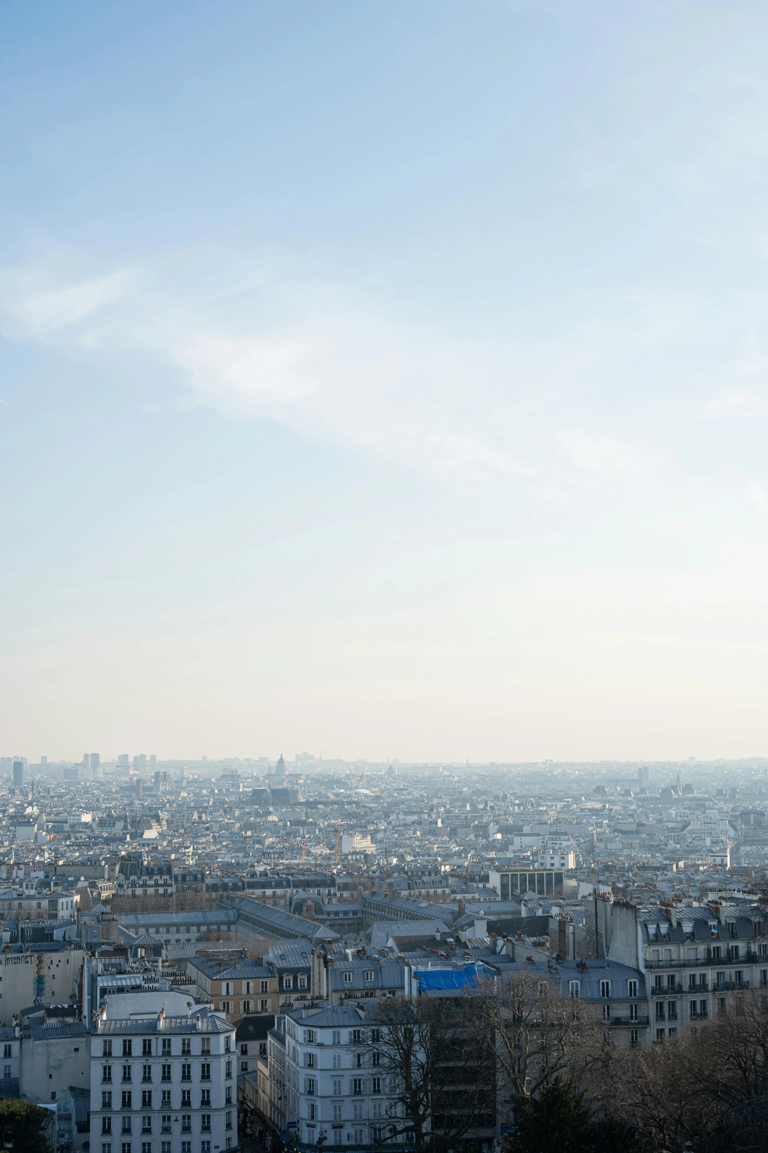 a city with lots of tall buildings sitting below a blue sky