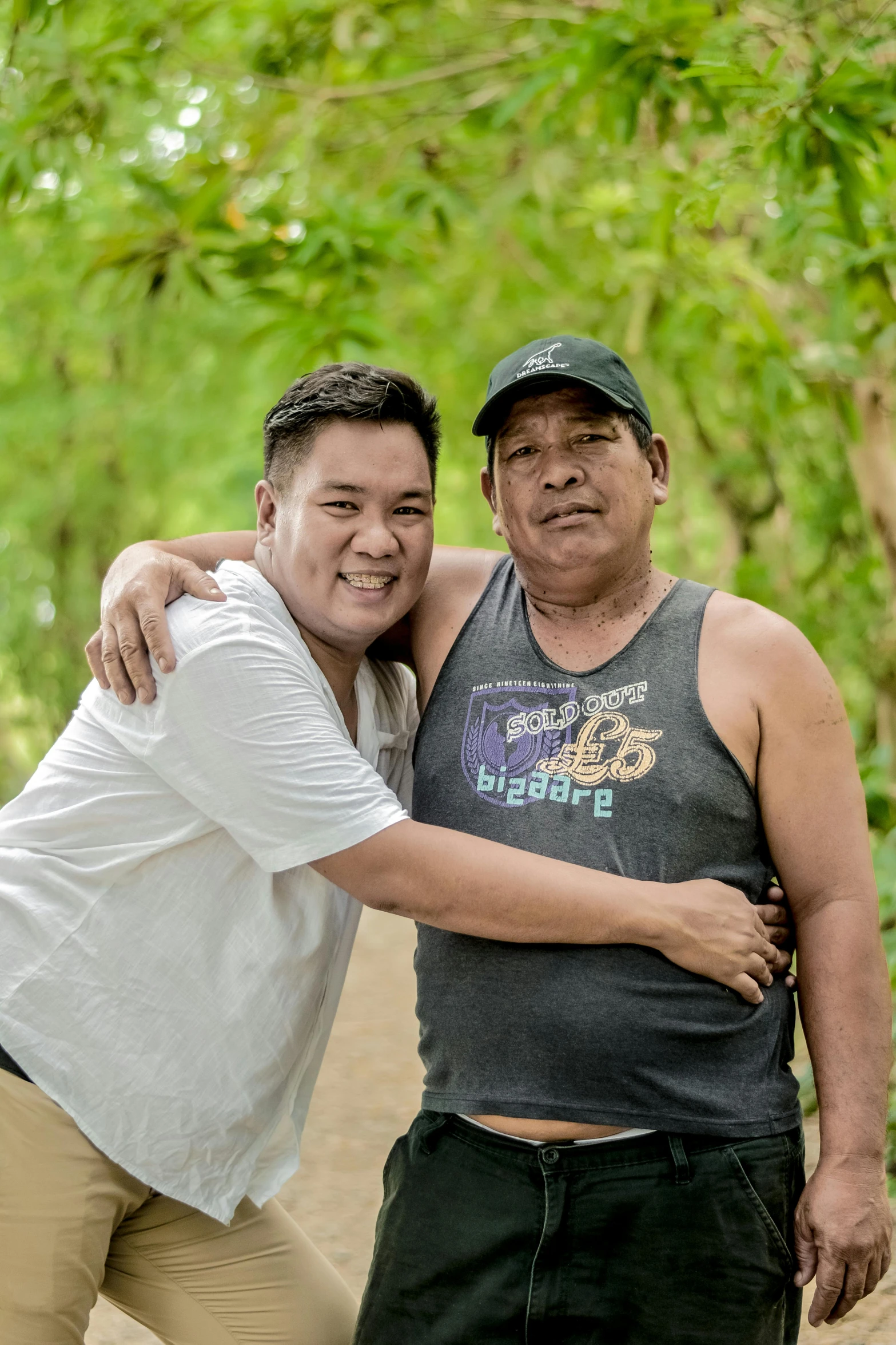 two men in the jungle are posing for a po