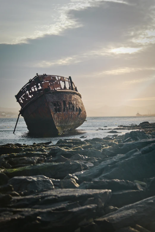 an old, rusty boat sits in the sea water
