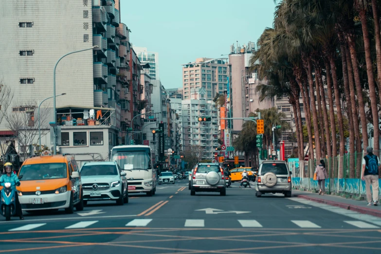 cars and motorcycles are driving down a busy street