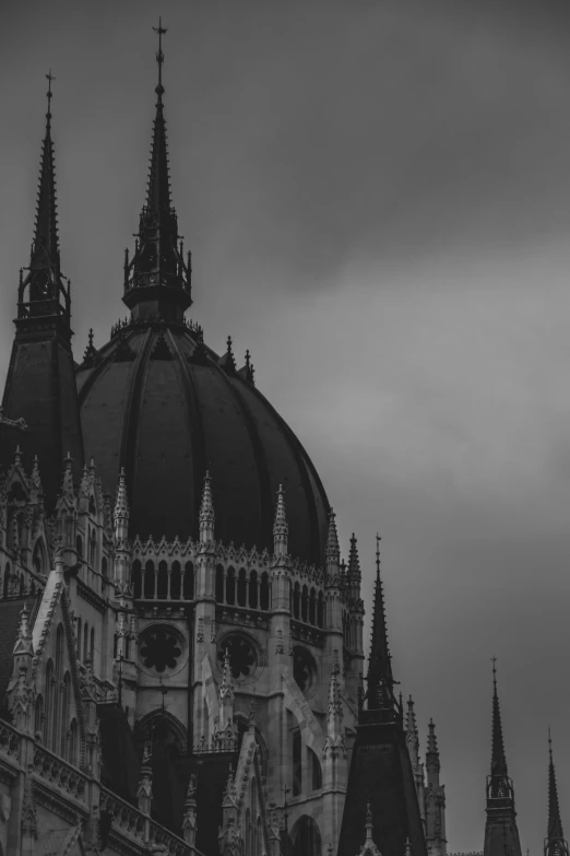 black and white image of large building with clocks