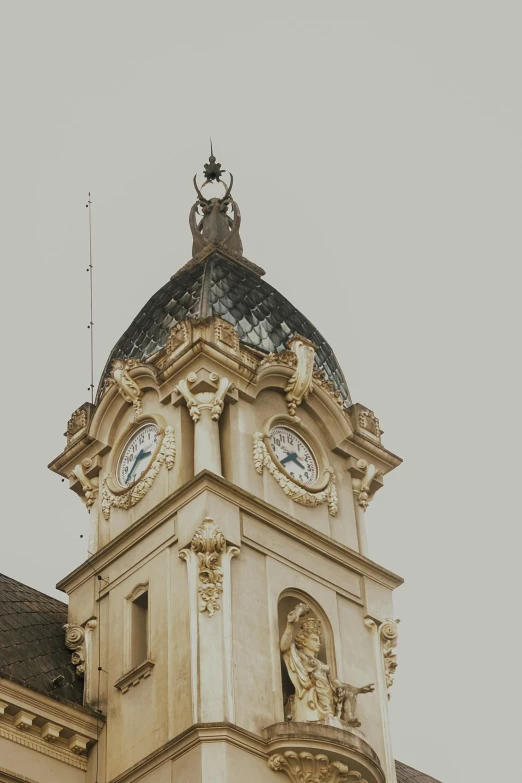 an ornate building with two clocks and a cupola on top