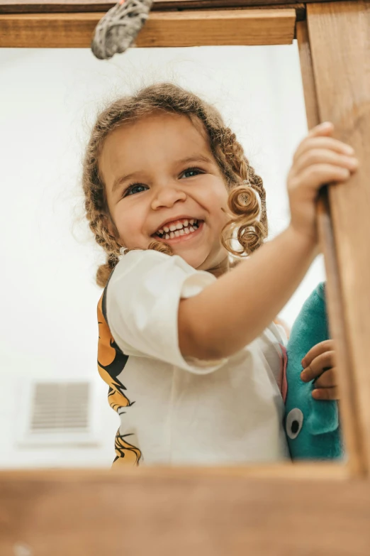 a  smiles while playing on the slide