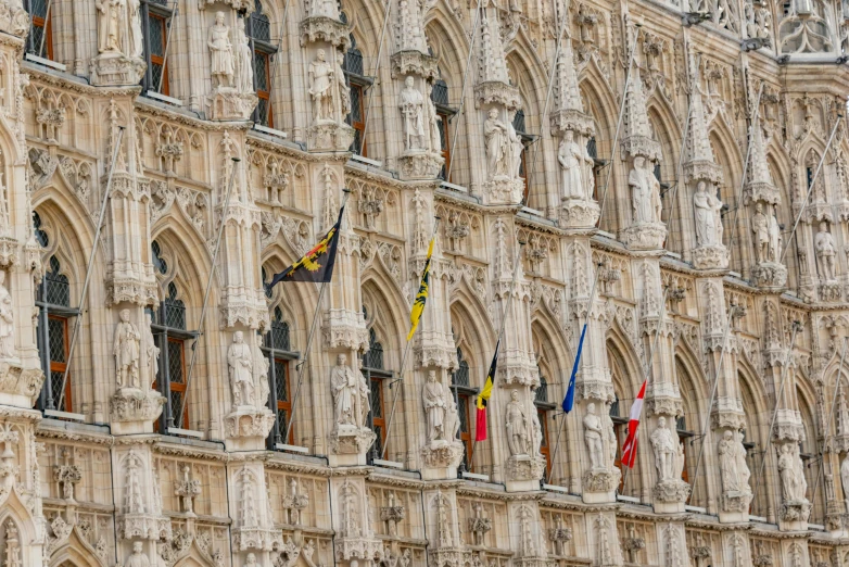 many flags in front of an old building