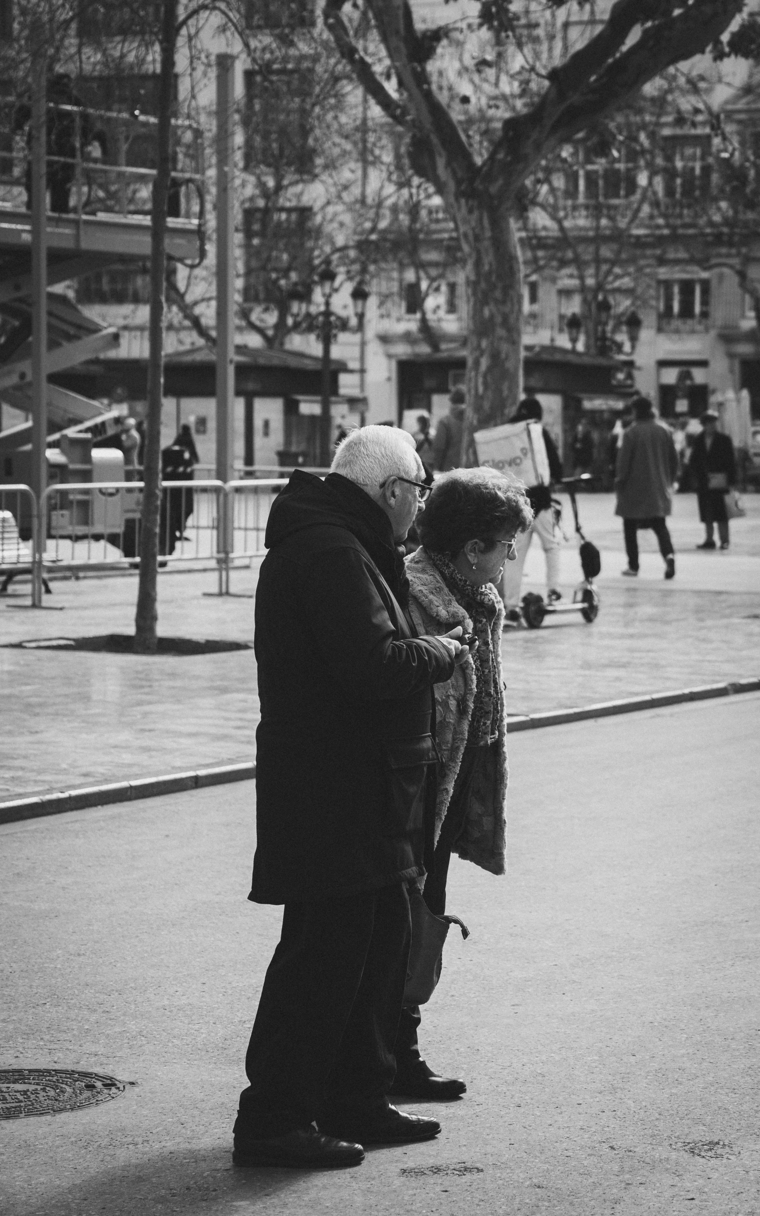 a couple are standing next to each other in a street