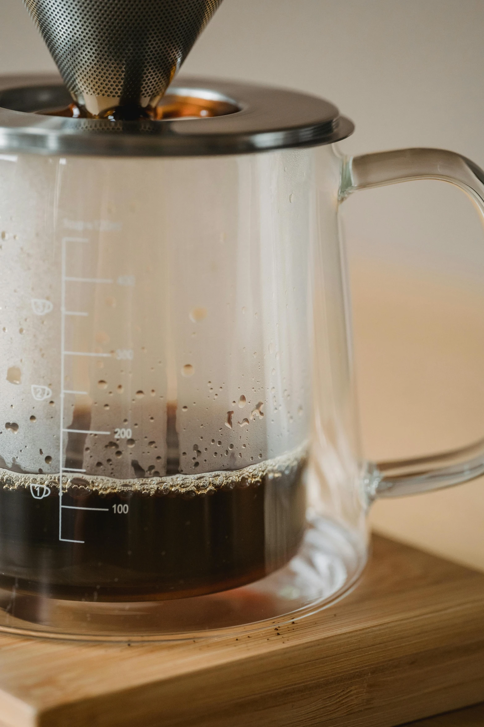 a glass coffee pot on top of a wooden counter