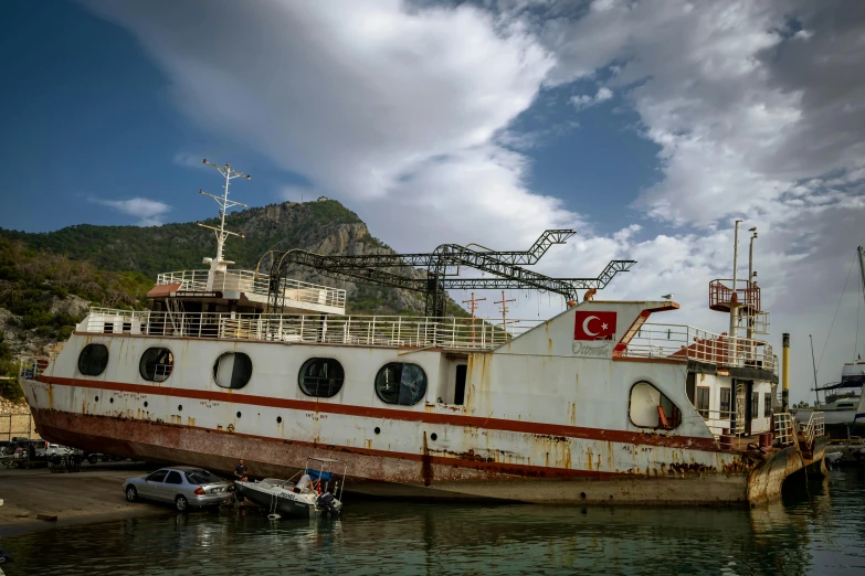 a rusted boat is parked at a dock