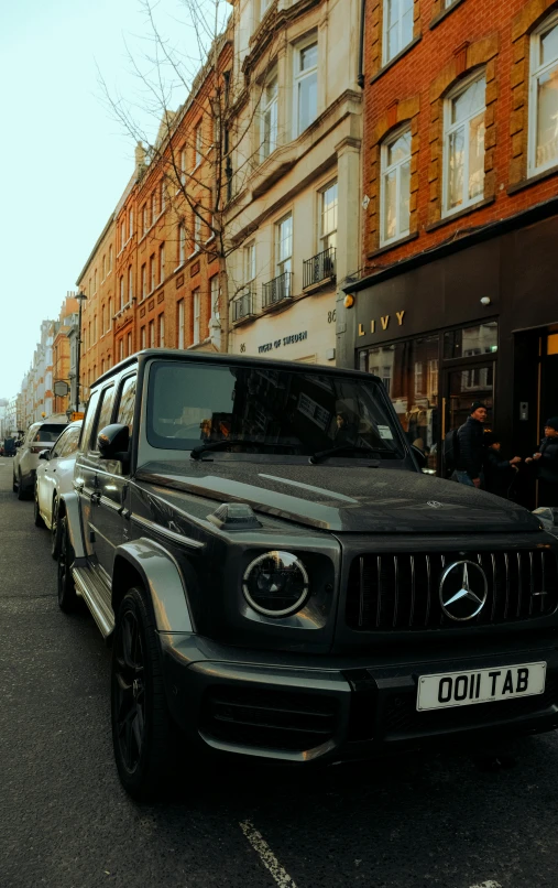 some cars parked on a city street near a brick building