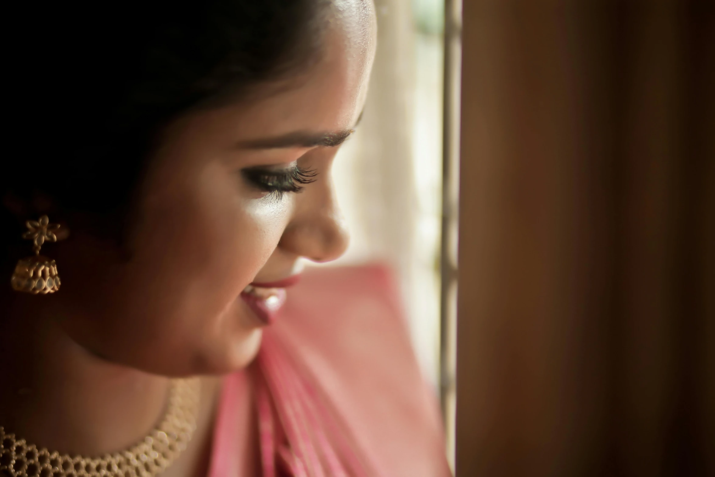 a woman in a pink shirt with a jewelry on her face