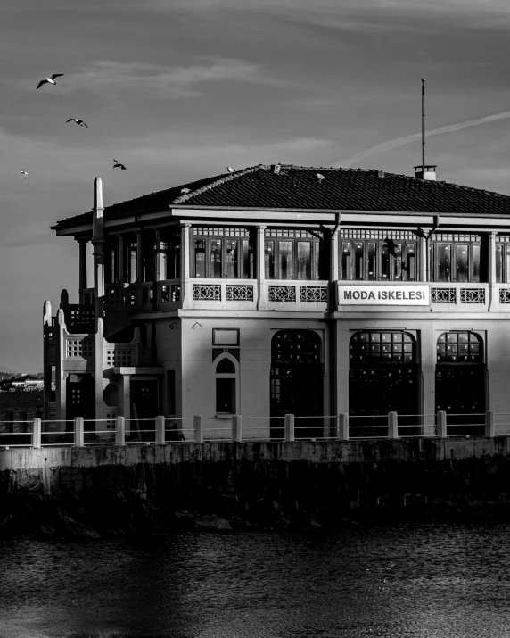 a large white building sitting next to a body of water