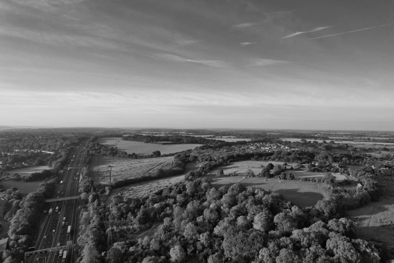 an aerial view of trees, roads and land