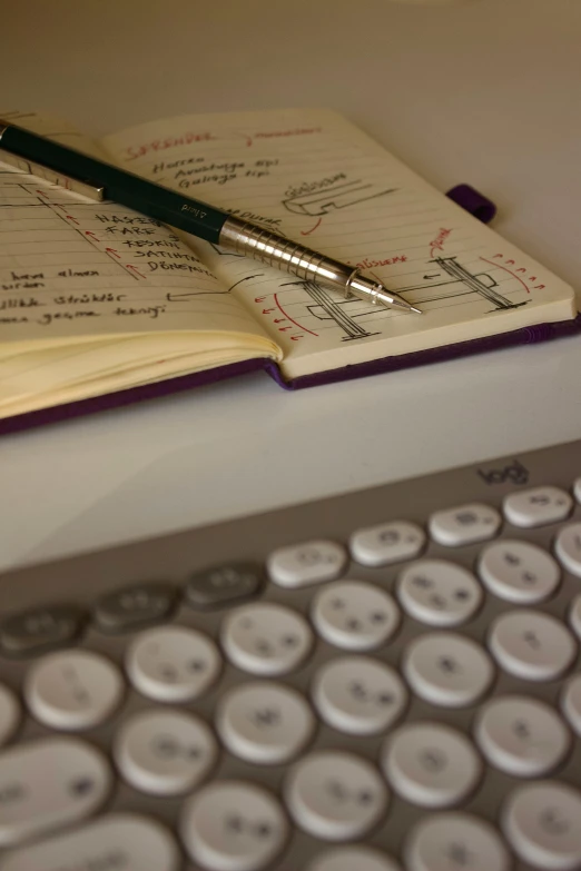 a book opened next to a keyboard and mouse