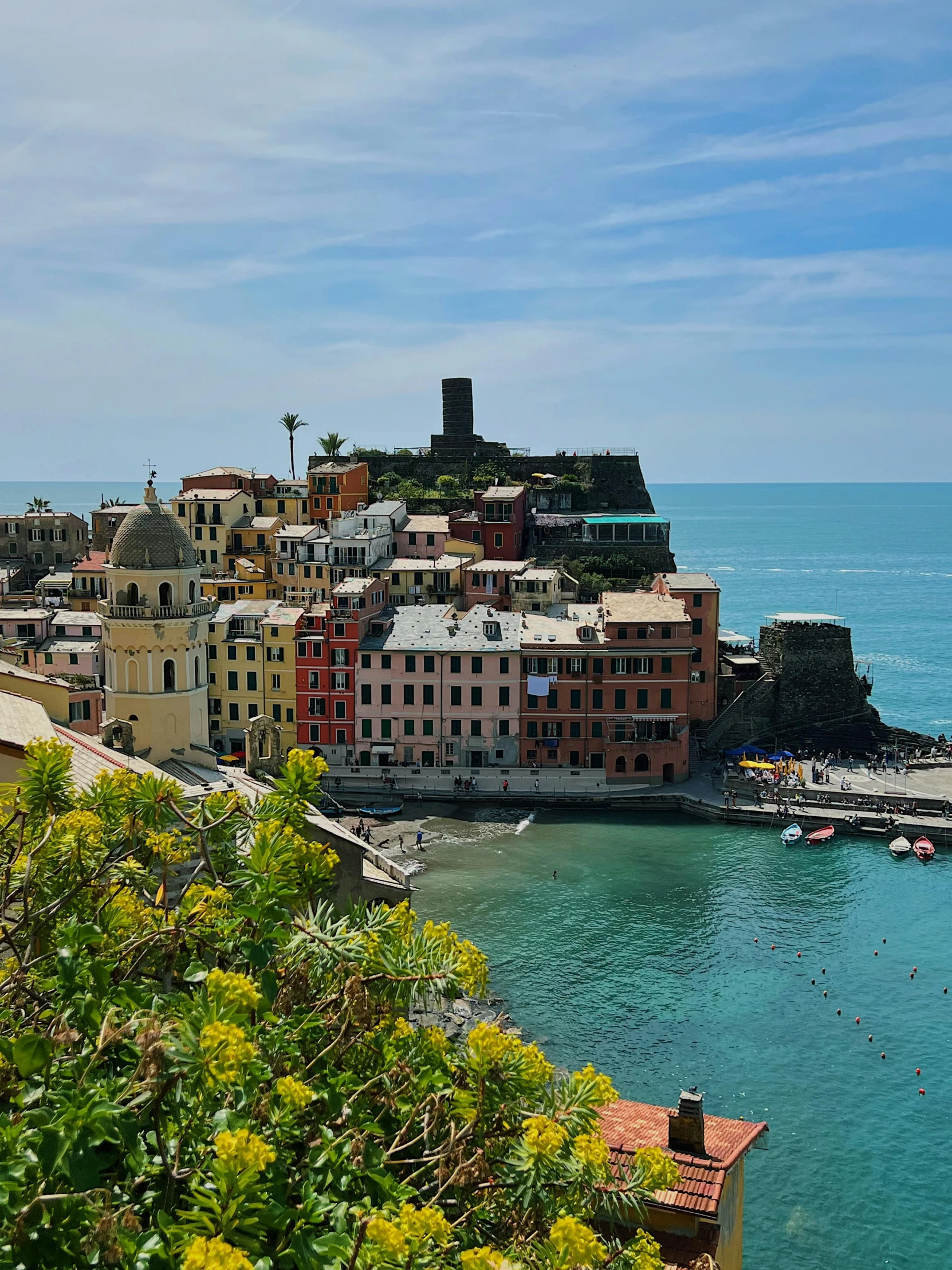 a small village on top of a cliff by the sea