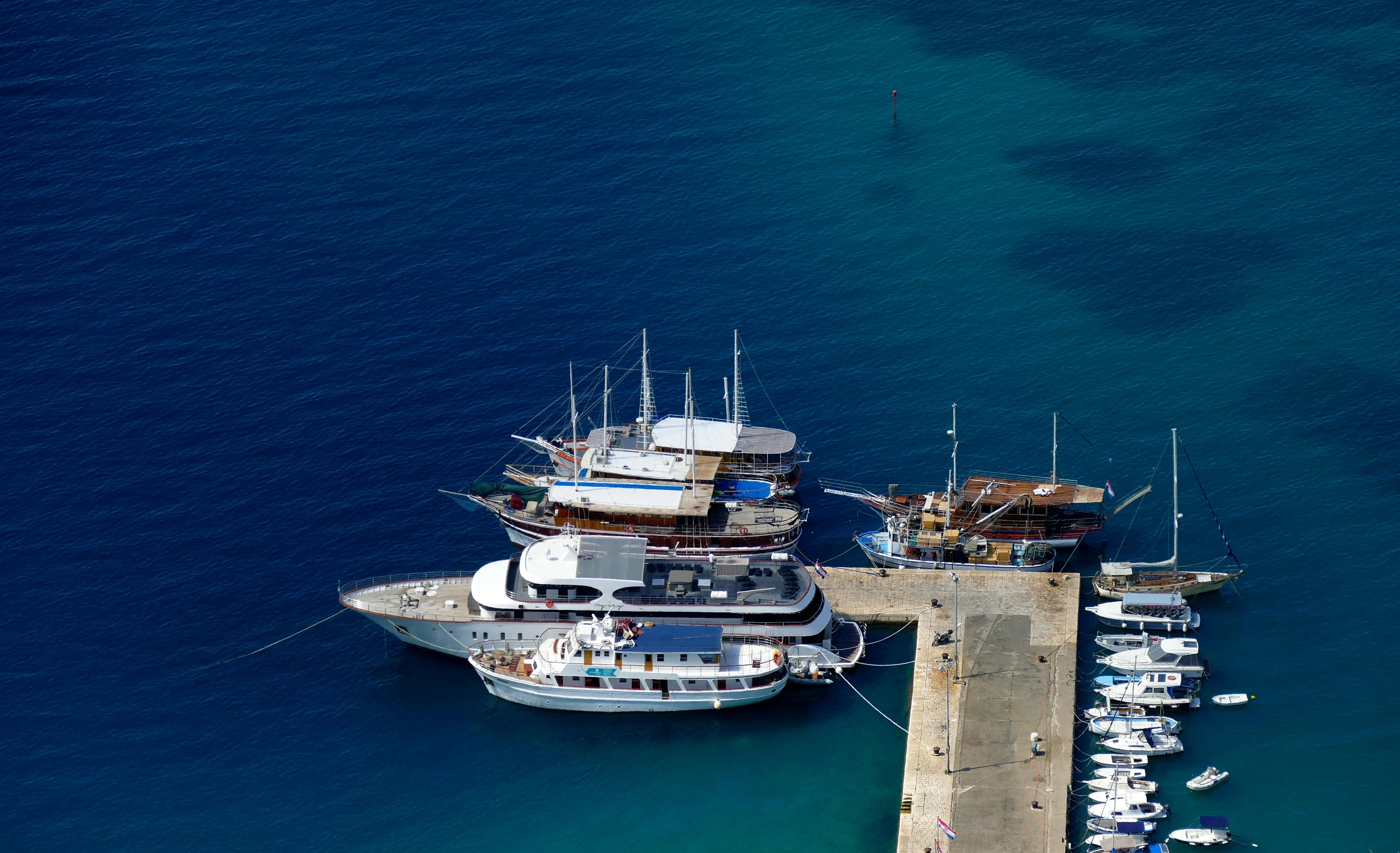 a large boat sits next to a marina pier