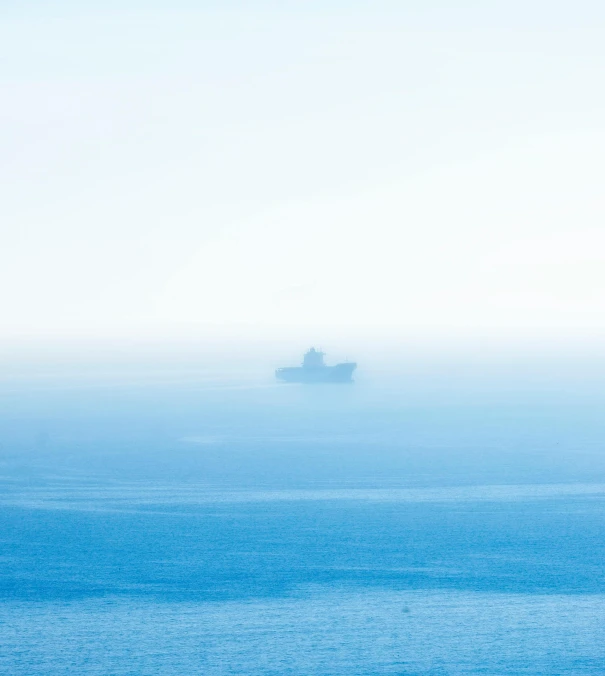 two ships in the distance on a foggy day