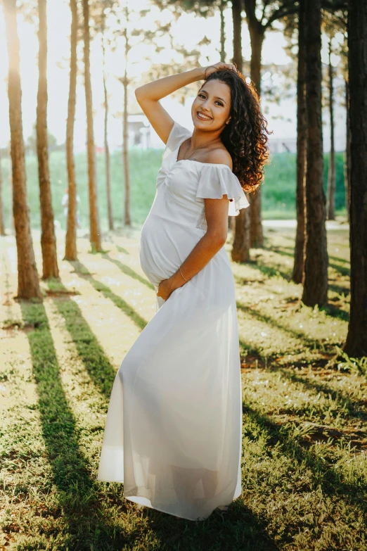 a pregnant woman posing for a po outdoors