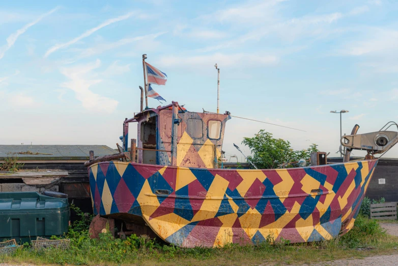 an unusual looking boat is sitting in a field