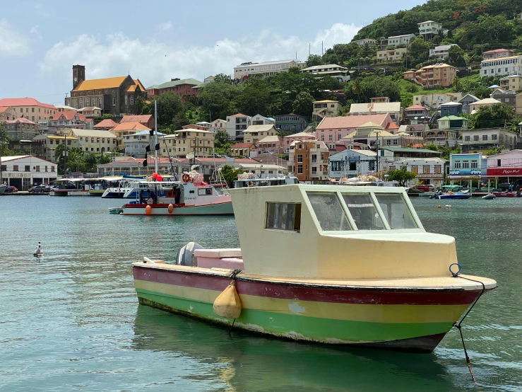 an empty boat floating in the water near town