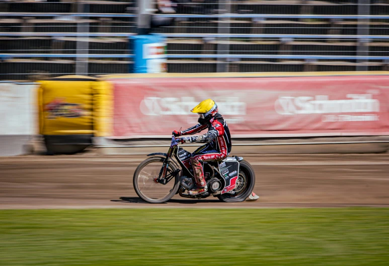 a man is riding on his motorcycle down the track