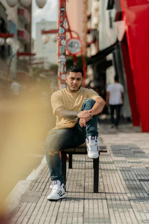 a man sitting on a bench next to a street