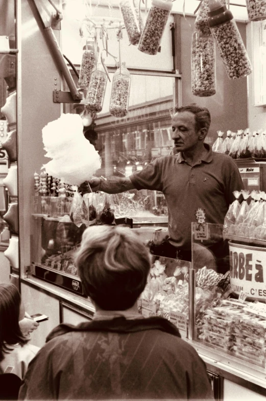 a man is at the grocery store selling his items