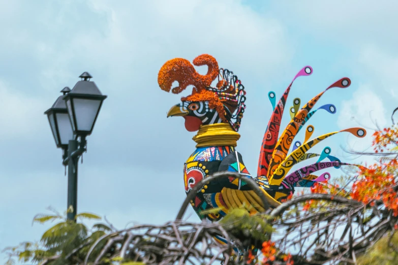 a rooster sculpture is on display outside of a building