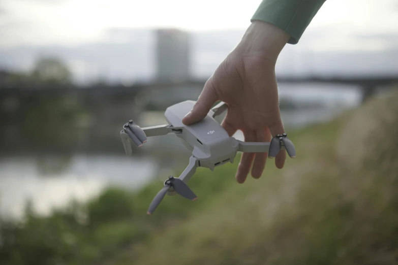 person holding a remote control for a small air plane