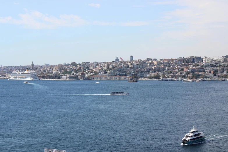 a ship in the ocean with a city in the background