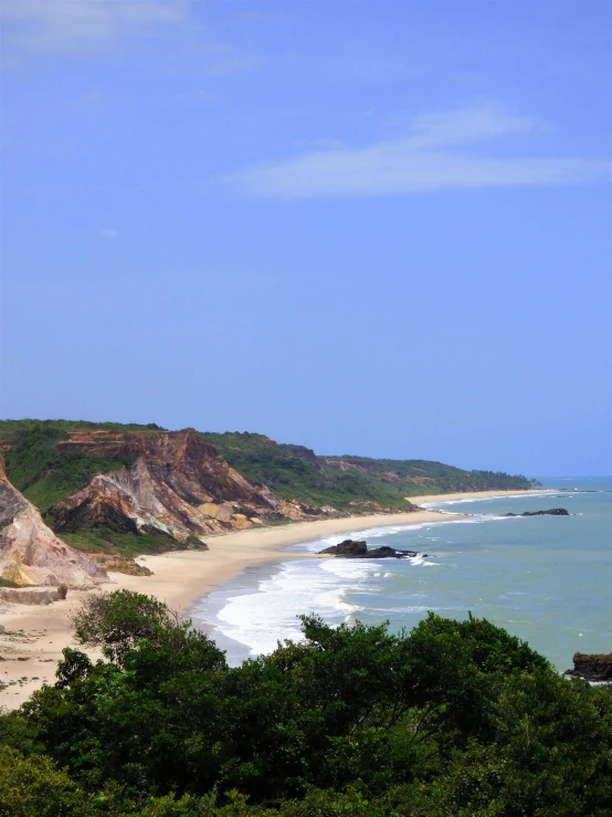 a sandy beach is by the ocean