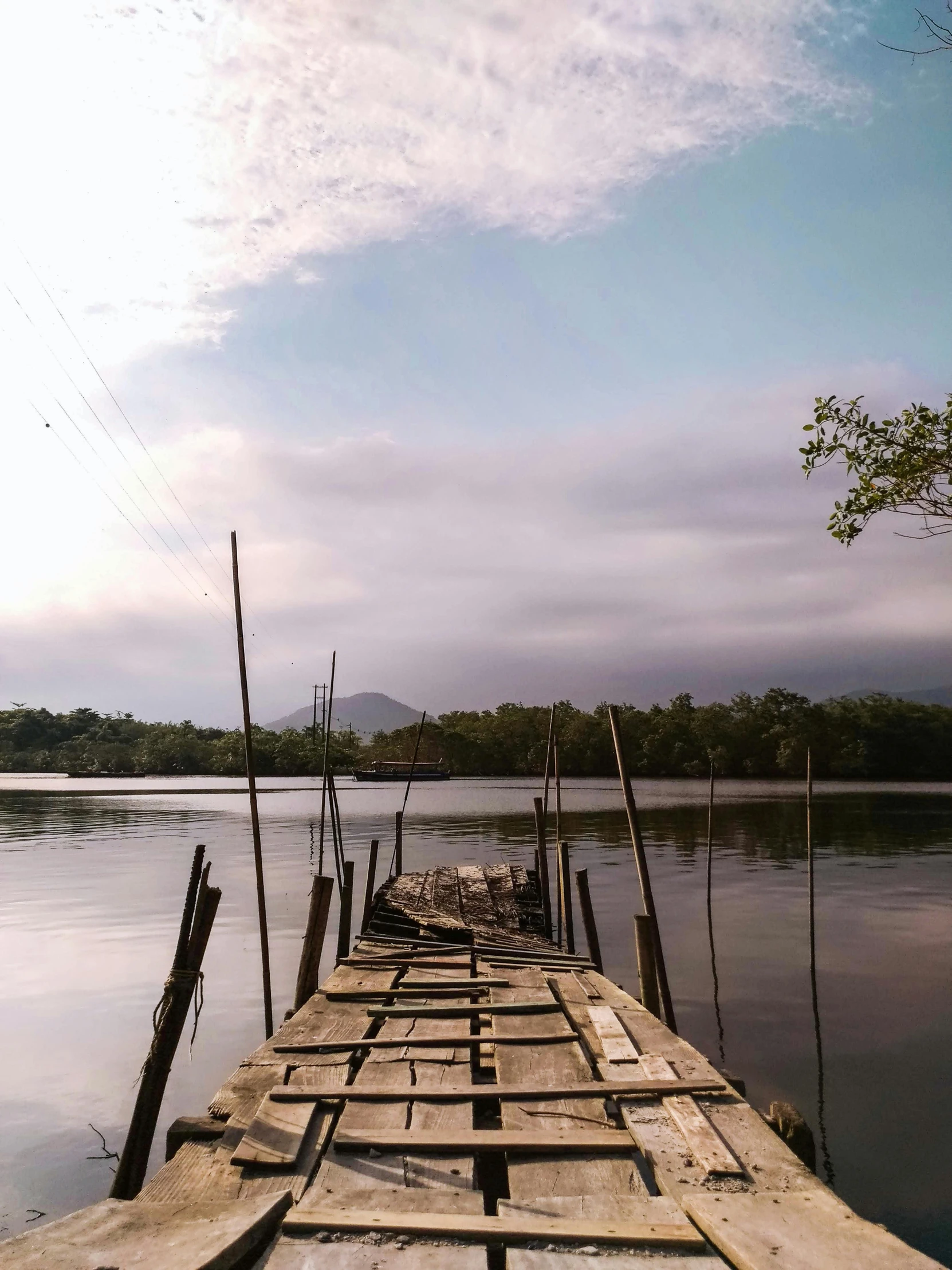 wooden raft on water in daytime with clouds