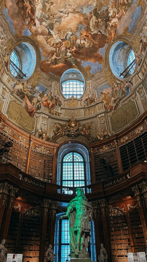 a view of a book room with bookshelves and a statue