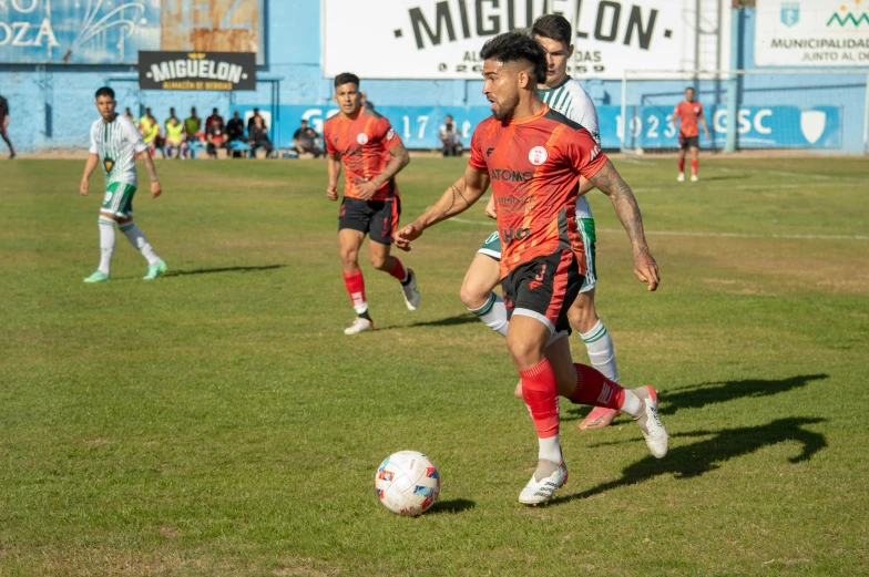 a group of young men kicking around a soccer ball