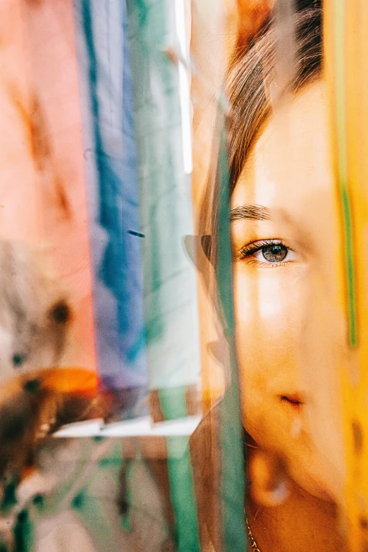 a woman with closed eyes looking through a window