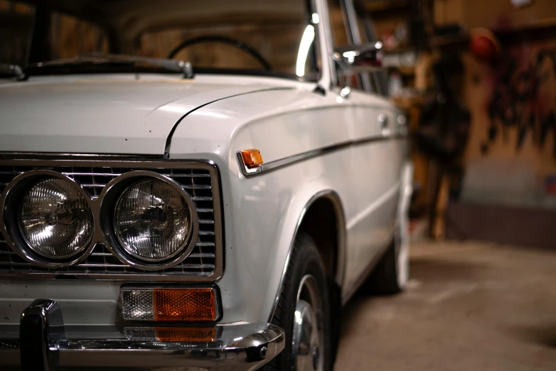 the front of an older car with a broken down grill