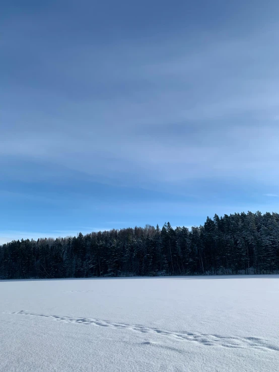 a lone snow skier traveling on the snowy field