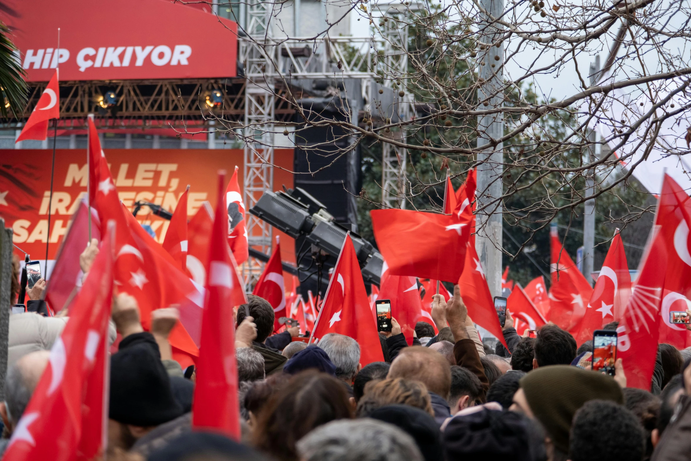 a large group of people with flags in a crowded place