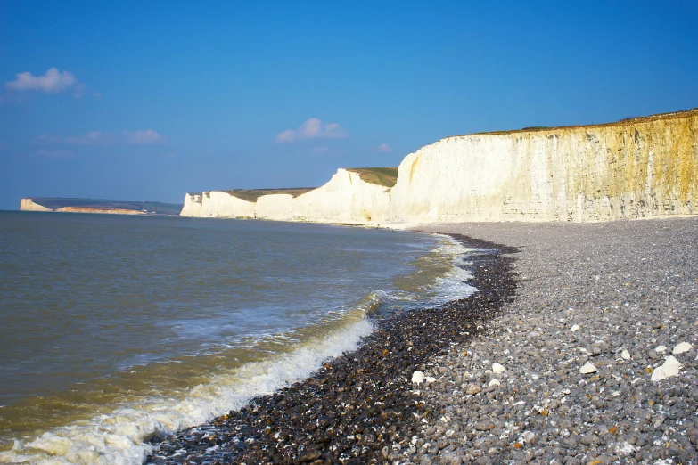 the shore of the sea next to an empty beach