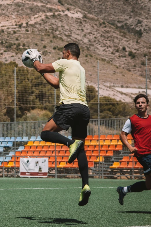 a person in the air jumping for a ball